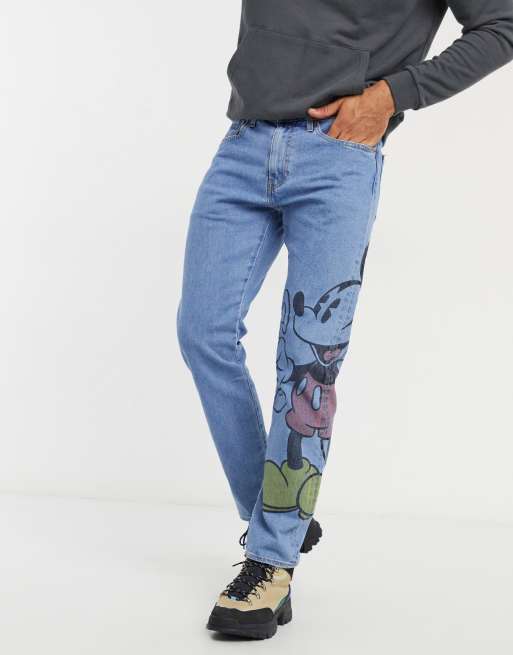 Levi's x Disney jeans with large Mickey Mouse graphic in blue mid wash |  ASOS