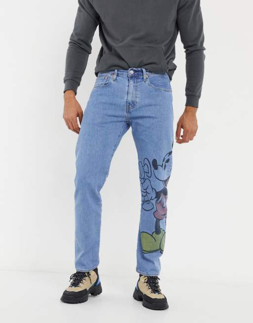 Levi s x Disney jeans with large Mickey Mouse graphic in blue mid wash