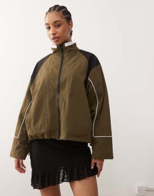Lioness - Shoreline - Oversize-Windjacke in Safari-Grün mit kontrastierender Paspelierung am Kragen