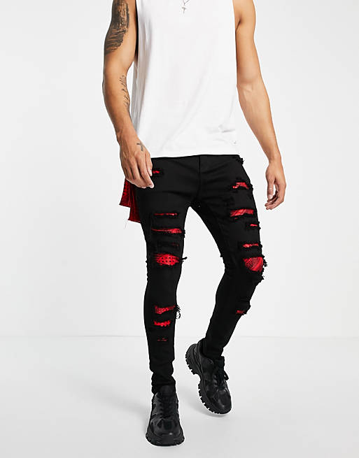 Liquor N Poker skinny jeans in black with red bandana distressed patches