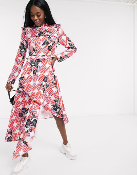 Liquorish – Langärmliges Kleid mit asymmetrischem Saum in Elfenbein mit orangefarbenem Print