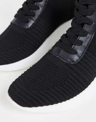 black sneakers with white bottoms