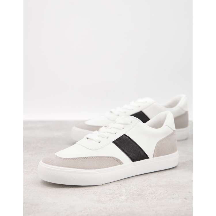 White shoes with black 2025 stripes on one side