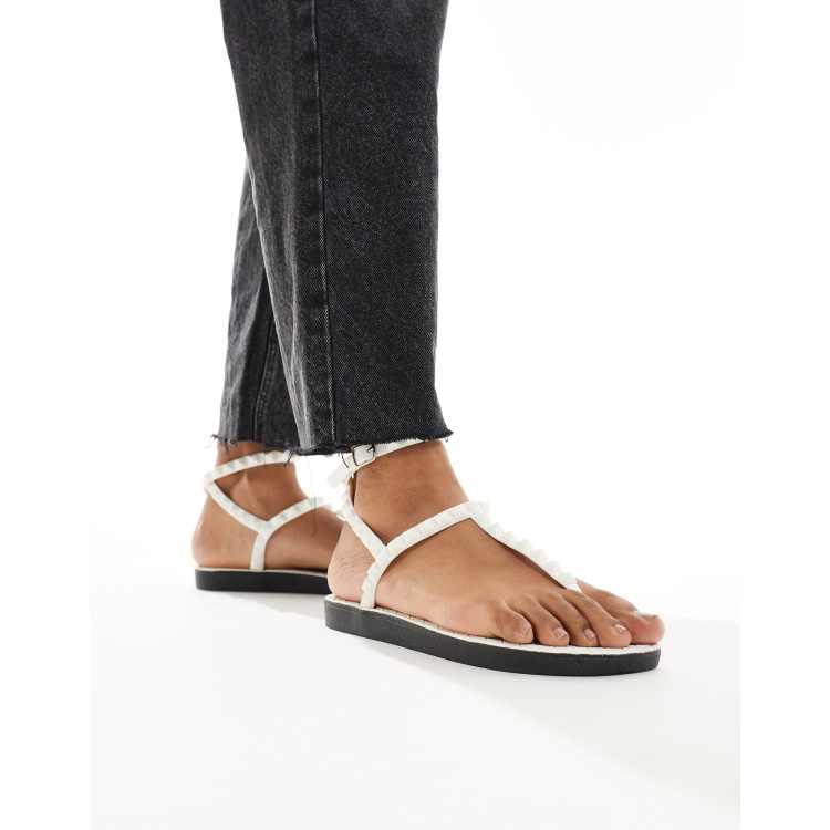 London Rebel studded t bar ankle strap jelly sandals in white ASOS