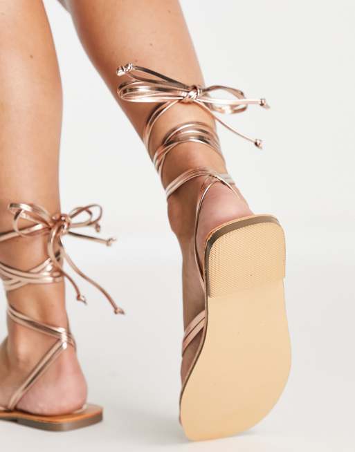 London Rebel tie leg flat sandals in gold metallic ASOS
