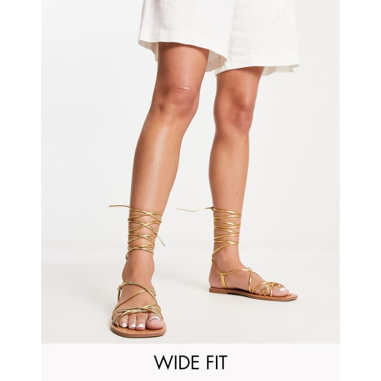 London Rebel Wide Fit strappy tie leg flat sandals in gold