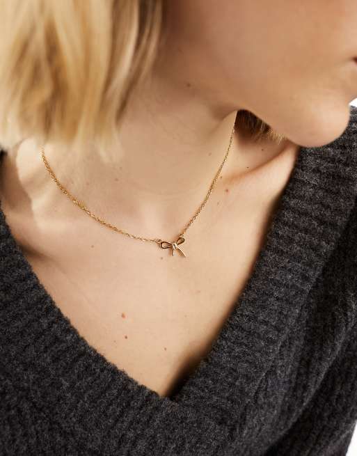 Lost Souls stainless steel bow pendant necklace in gold