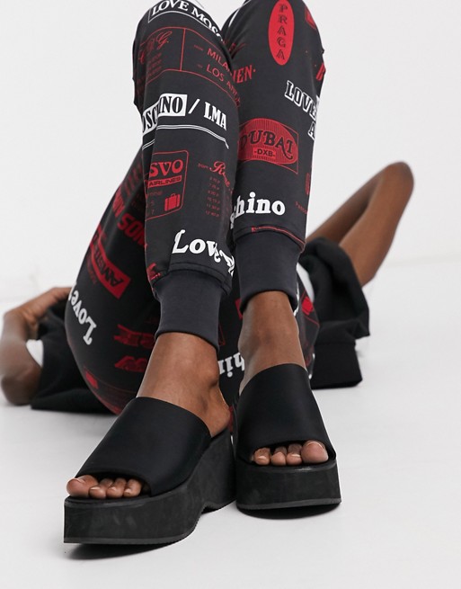 Love Moschino allover printed logo joggers in black