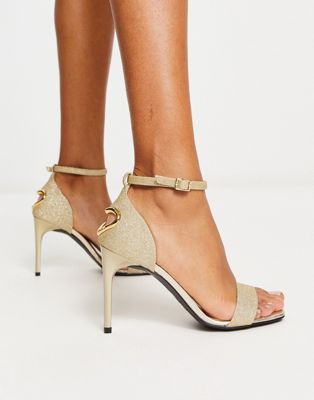 Love Moschino heart detail stiletto heel barely there sandals in gold glitter
