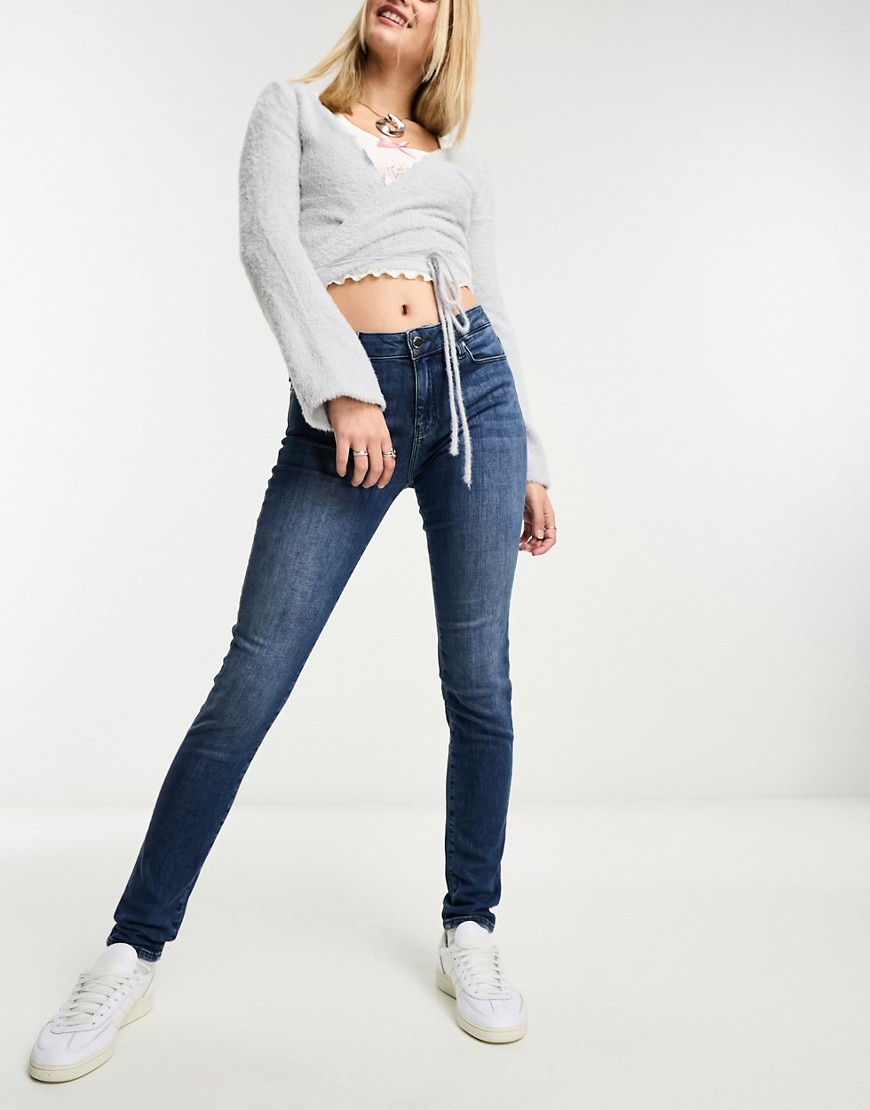 Love Moschino heart print logo skinny jeans in mid blue wash