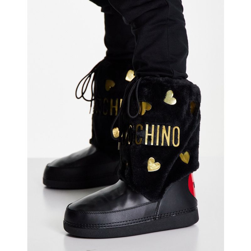 Designer  Love Moschino - Stivali da neve con pelliccia sintetica con cuori nero e oro