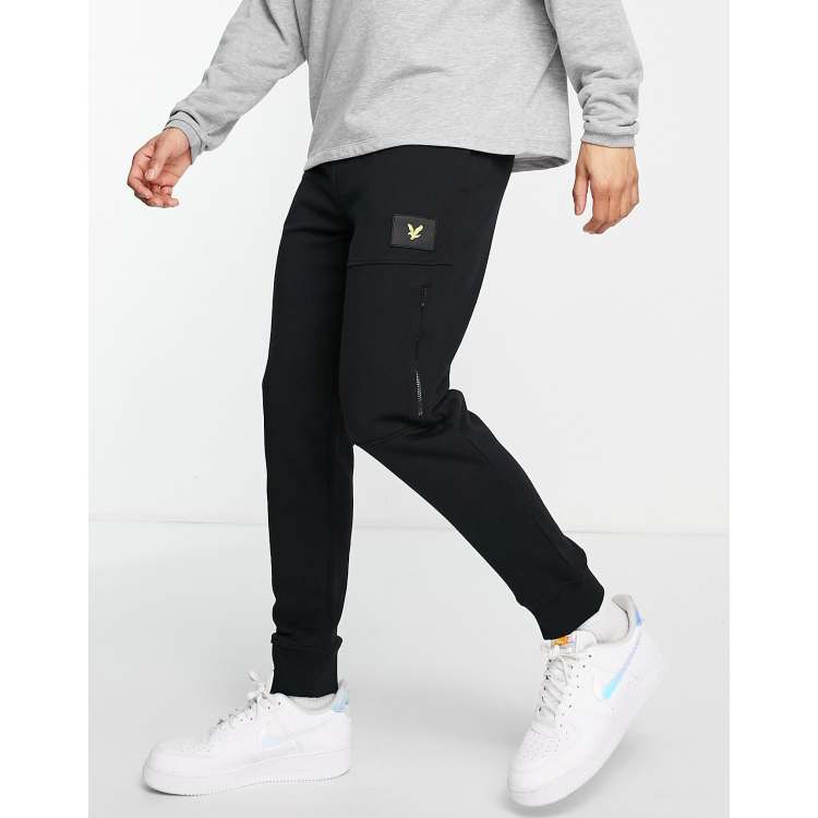 Lyle Scott badge logo track pants in black ASOS