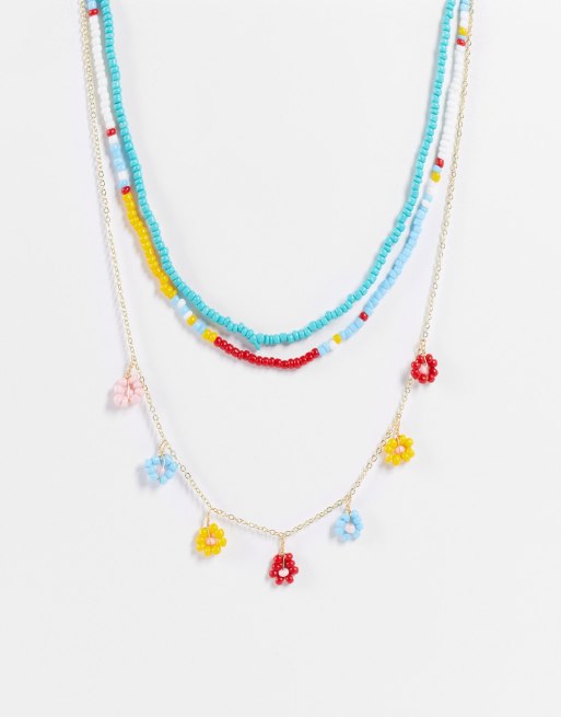 Madein - Meerlaagse ketting met kralen en bloemenhangertjes