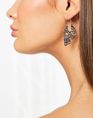 Madein. skull earrings in silver