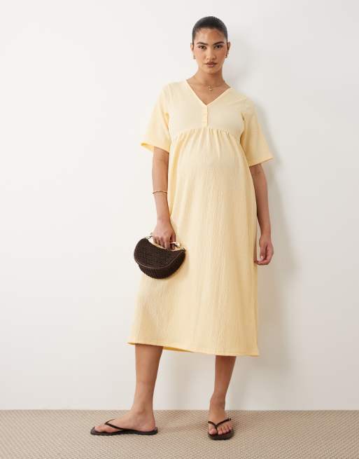 Mamalicious Maternity short sleeve nursing button detail textured jersey  midi dress in yellow | ASOS
