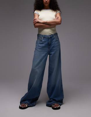 Mango - Aba - Weit geschnittene Jeans in Blau mit abgesetztem Saum