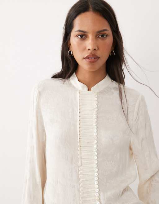 Mango blusa jacquard a collo alto a maniche lunghe con dettagli a bottoni in bianco sporco