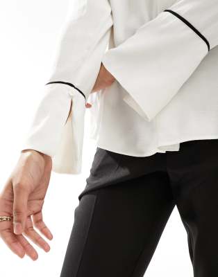 beige blouse with white piping