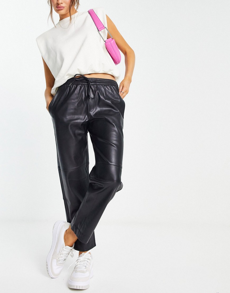 Mango faux leather joggers in black
