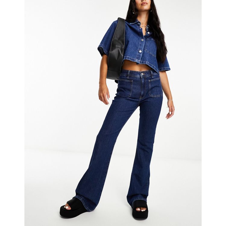 ASOS DESIGN low rise flared jeans with western pocket detail in dark blue