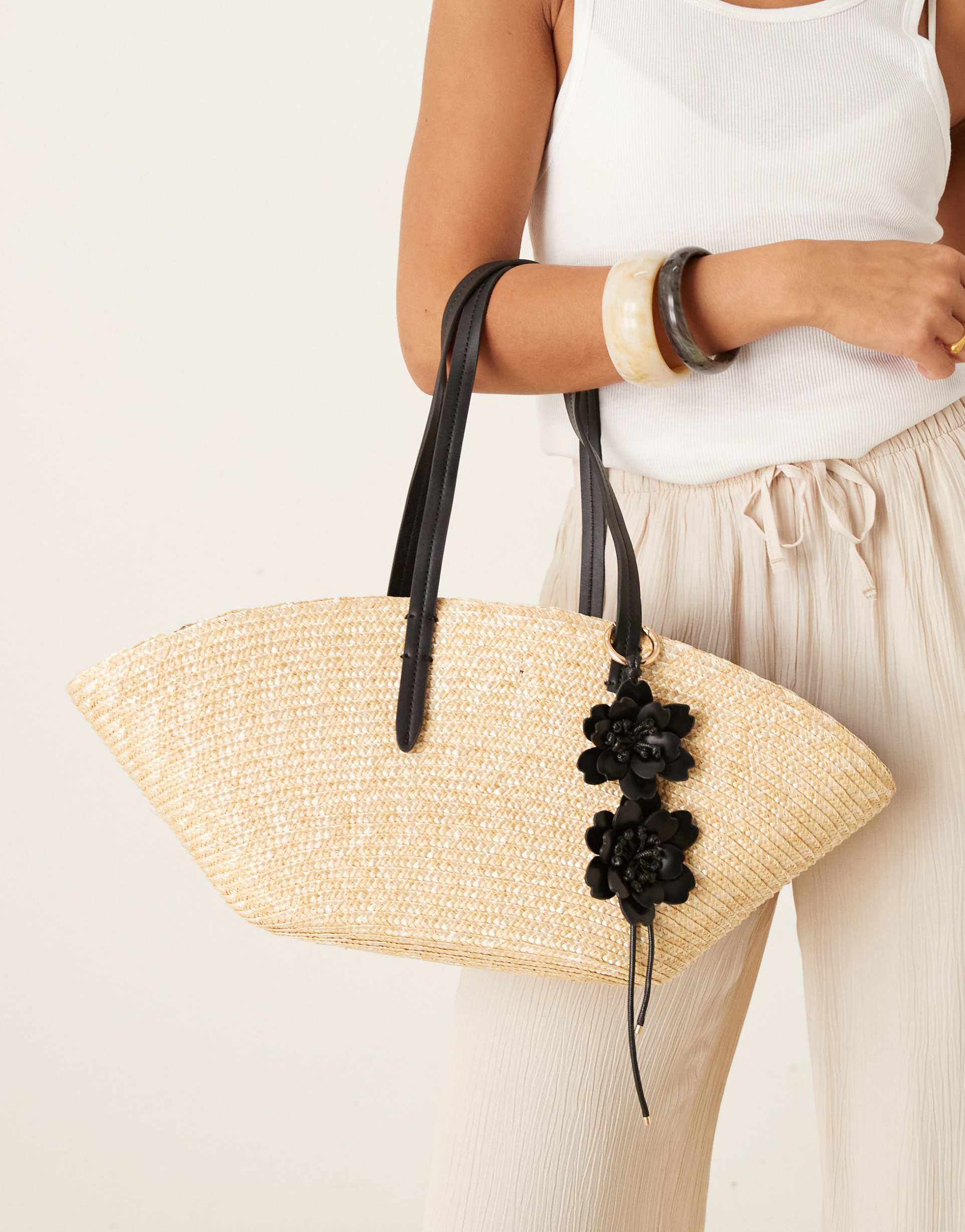 mango woven straw bag with flower charm in tan