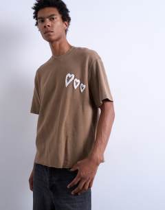 Model wearing Mason Newman x Topman boxy fit t-shirt with heart front and back print in washed brown 