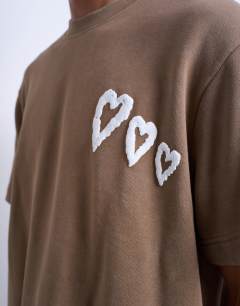 Model wearing Mason Newman x Topman boxy fit t-shirt with heart front and back print in washed brown 