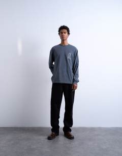 Model wearing Mason Newman x Topman relaxed fit long sleeve t-shirt with cowboy boot front and back print in washed black