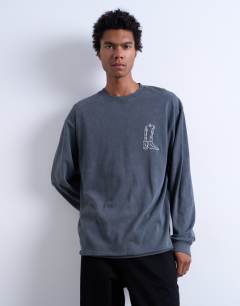 Model wearing Mason Newman x Topman relaxed fit long sleeve t-shirt with cowboy boot front and back print in washed black