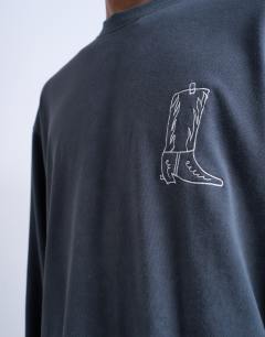 Model wearing Mason Newman x Topman relaxed fit long sleeve t-shirt with cowboy boot front and back print in washed black