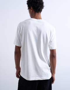 Model wearing Mason Newman x Topman relaxed fit t-shirt with cowboy skull print in ecru