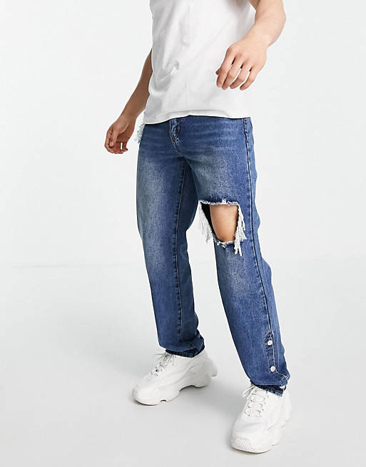 Mennace baggy jeans in vintage denim blue with rips and popper hems