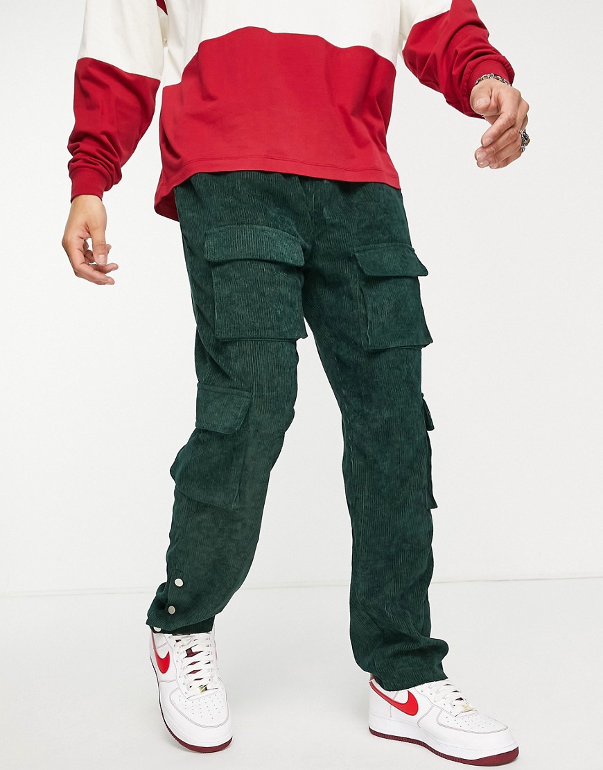 Mennace cargo trousers in green cord with popper hem