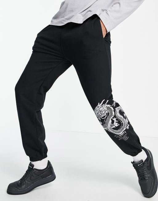 Mennace joggers in black with dragon and logo placement print ASOS