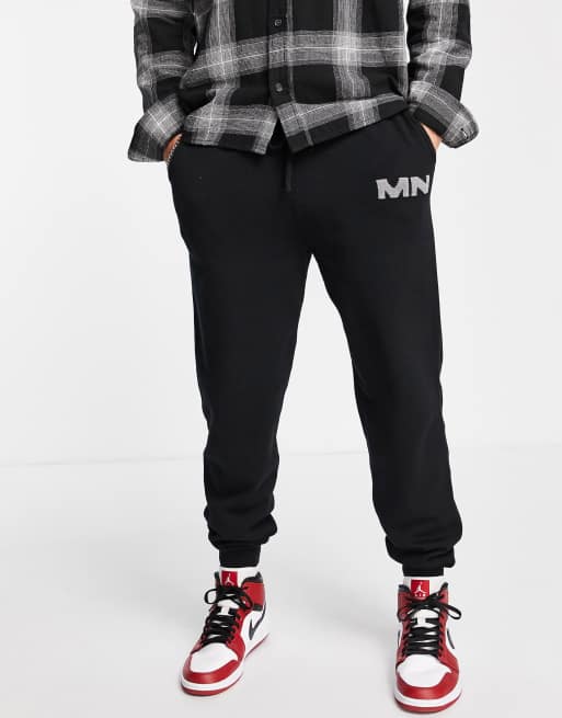 Mennace - Joggers in maglia nera con logo in coordinato