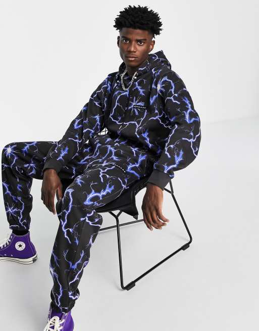 Mennace trackies in black with all-over lightning print (Part of a co-ord)