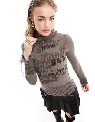 Minga London distressed roll neck jumper with retro graphics in taupe