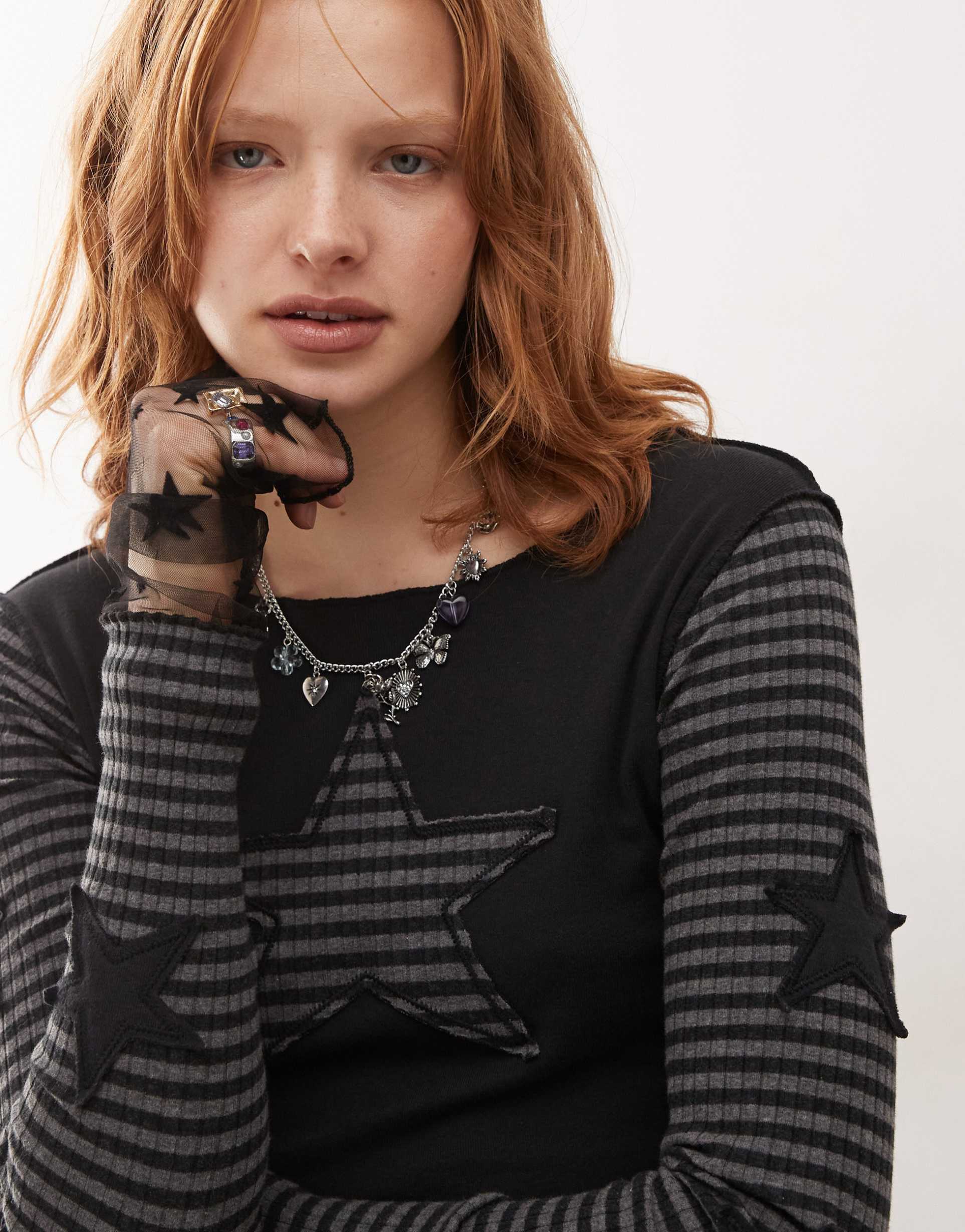 minga london long sleeve striped star patch top in black and gray