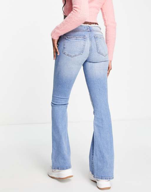 ASOS DESIGN low rise flared jeans with western pocket detail in dark blue