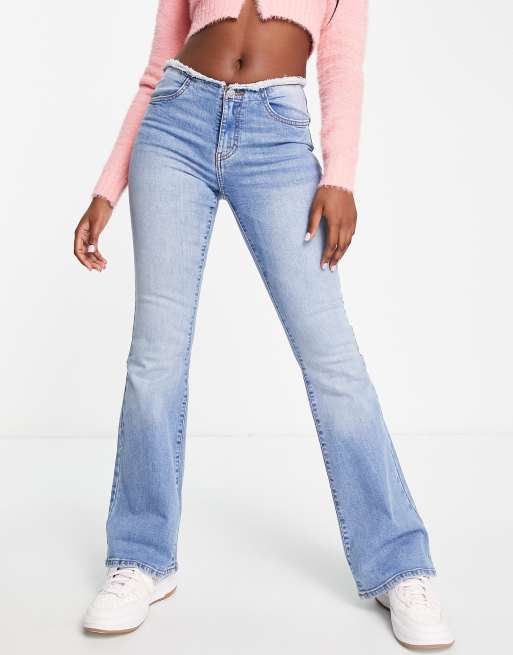 Miss Selfridge low rise raw waistband flare jean in mid wash blue