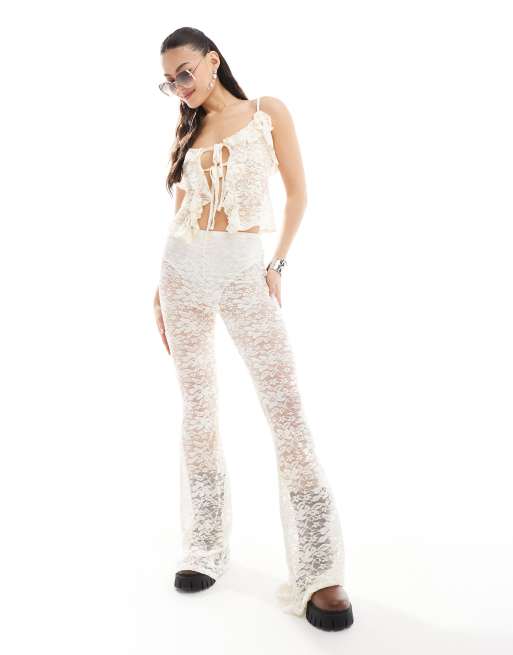 Miss Selfridge - Pantaloni da spiaggia a zampa in pizzo trasparente