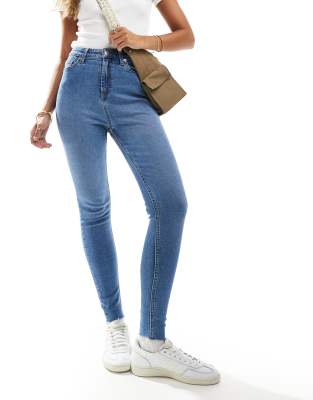 skinny high rise jeans in mid blue wash