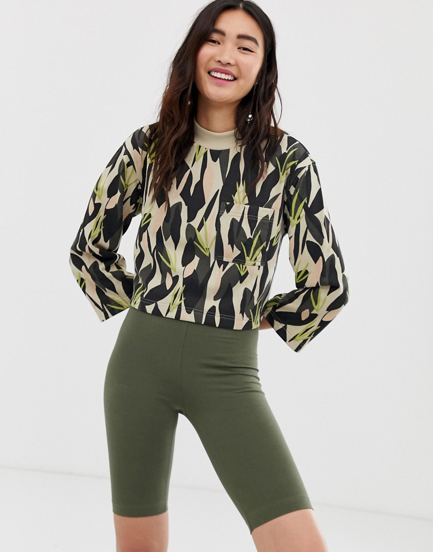 Monki camo print cropped jersey top with oversized pocket in green-Multi