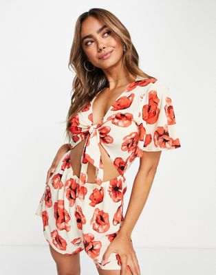 Monki relaxed playsuit with tie front and frill sleeves in poppy print - ASOS Price Checker