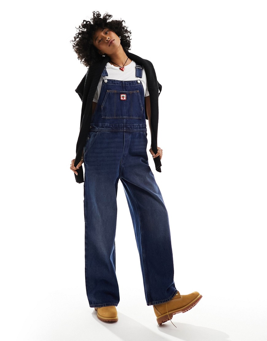 denim overalls with strawberry embroidery in mid wash blue