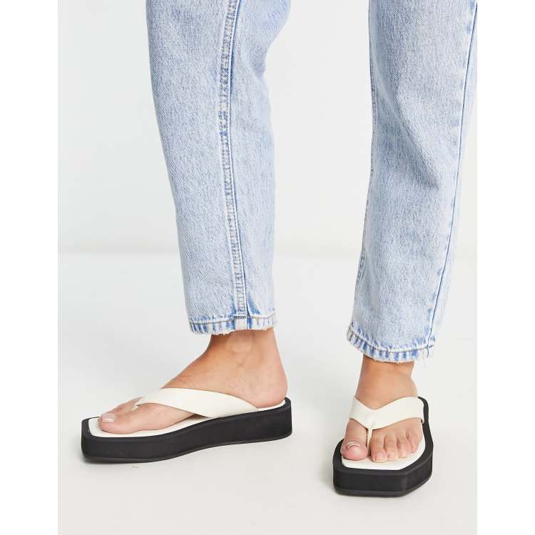 Monki faux leather thong sandals in black and white