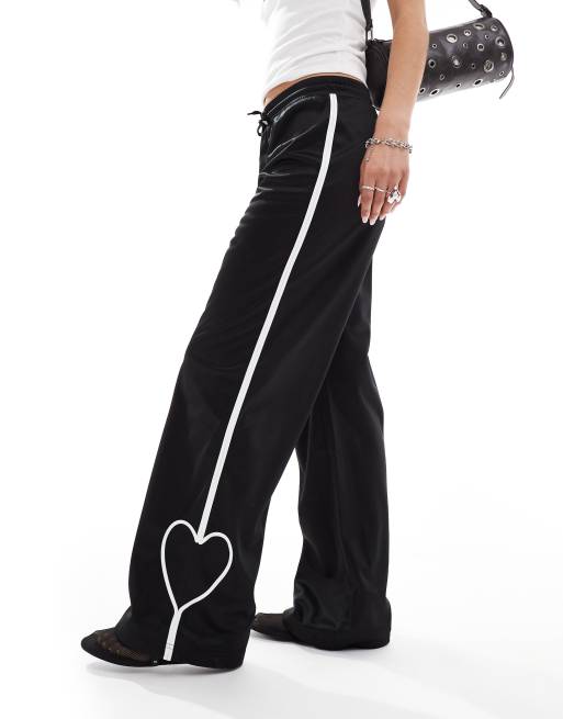 Monki heart stripe straight leg track pants in black with white