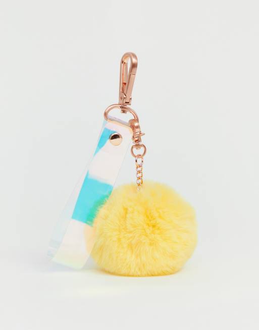 Monki - Holografische keycord met pompons van imitatiebont