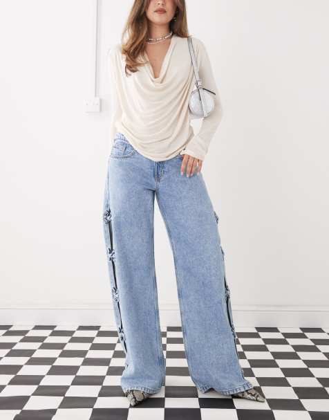 Monki Imoo low waist wide leg jeans with cut out bow details in light blue wash