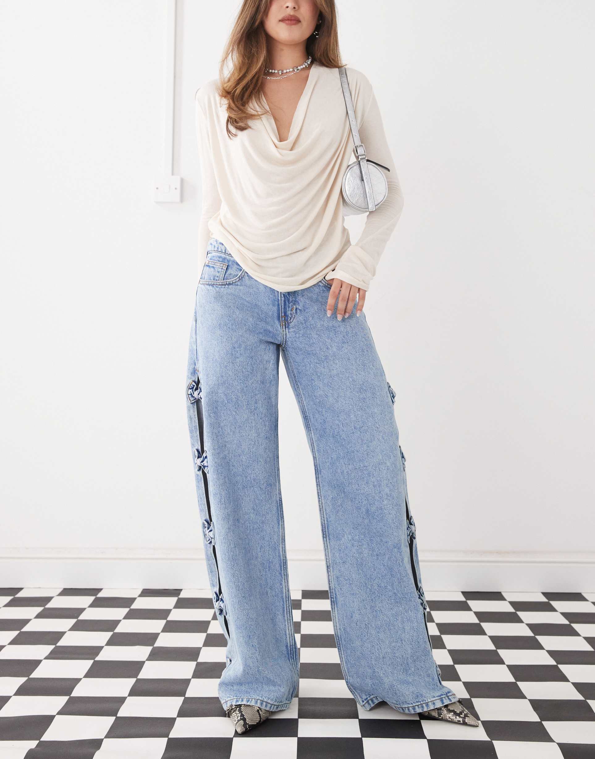 monki imoo low waist wide leg jeans with cut out bow details in light blue wash